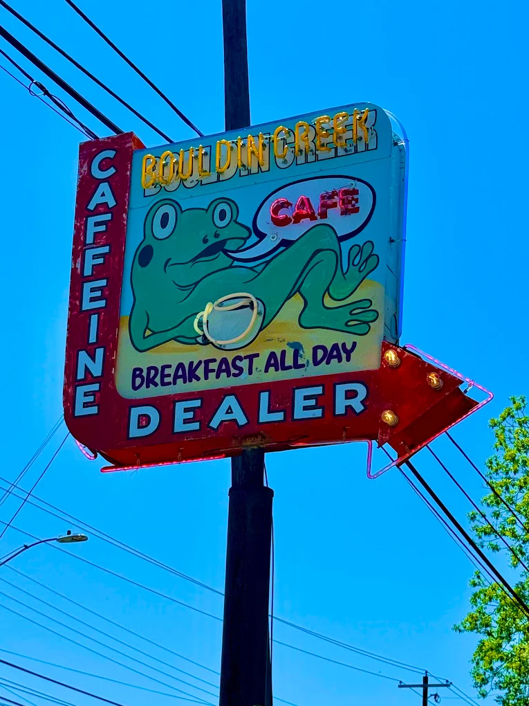 Bouldin Creek Cafe's neon sign, featuring a frog and reading "caffeine dealer"