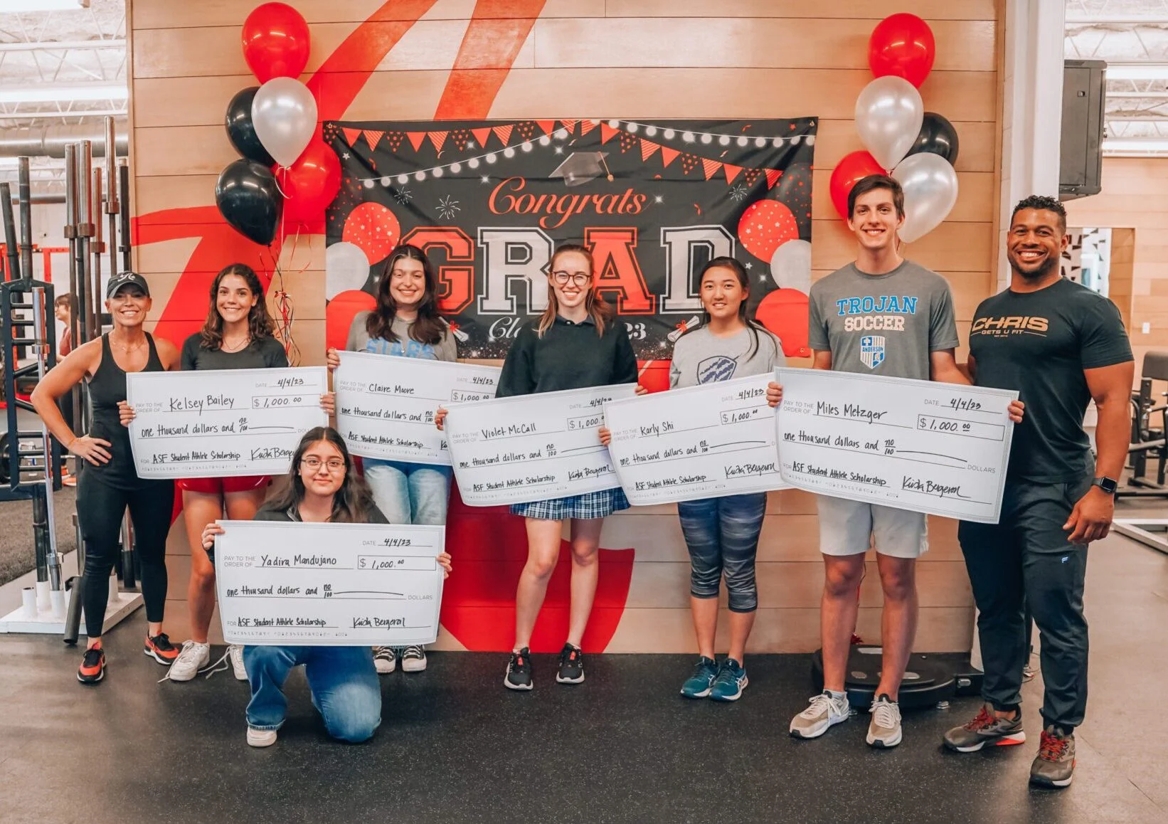 Scholarship recipients receive oversized checks