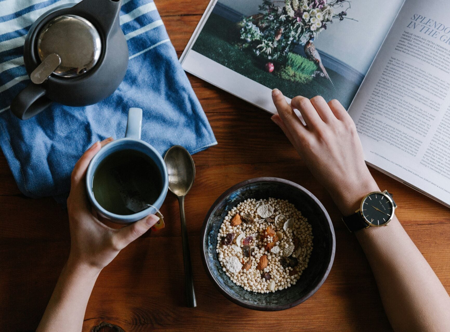 A bowl of oatmeal, cup of coffee and a magazine