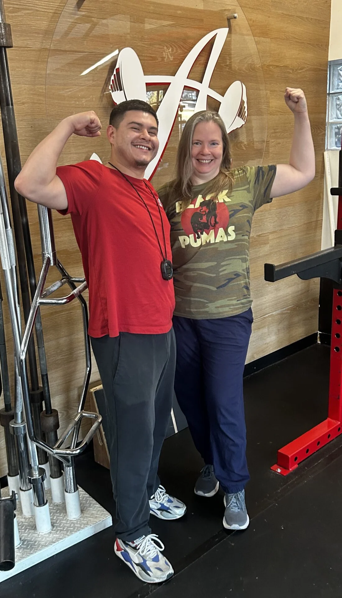 Client highlight Shannon and her trainer Jason flexing