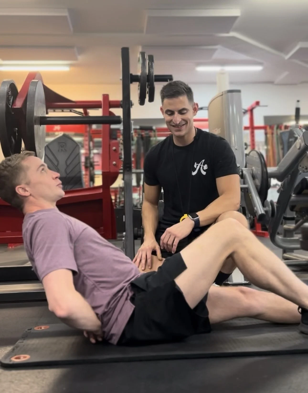 Client Highlight Gregory doing a core exercise with his personal trainer Danny