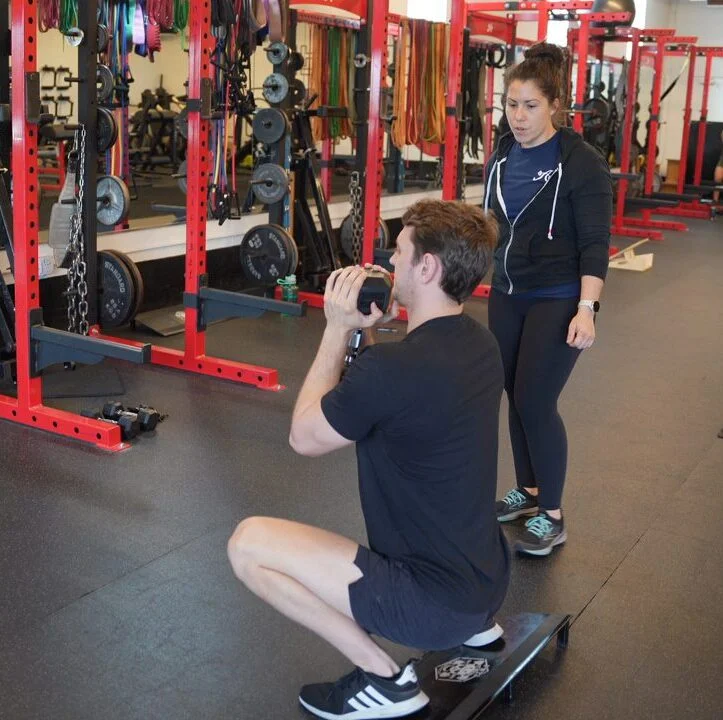 Trainer Ashley coaches a goblet squat