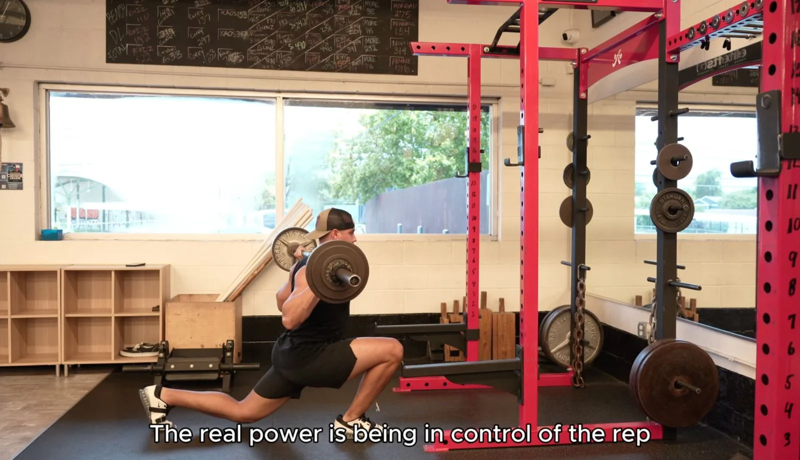 Man performs a barbell split squat. Text on the image reads "the real power is being in control of the rep"