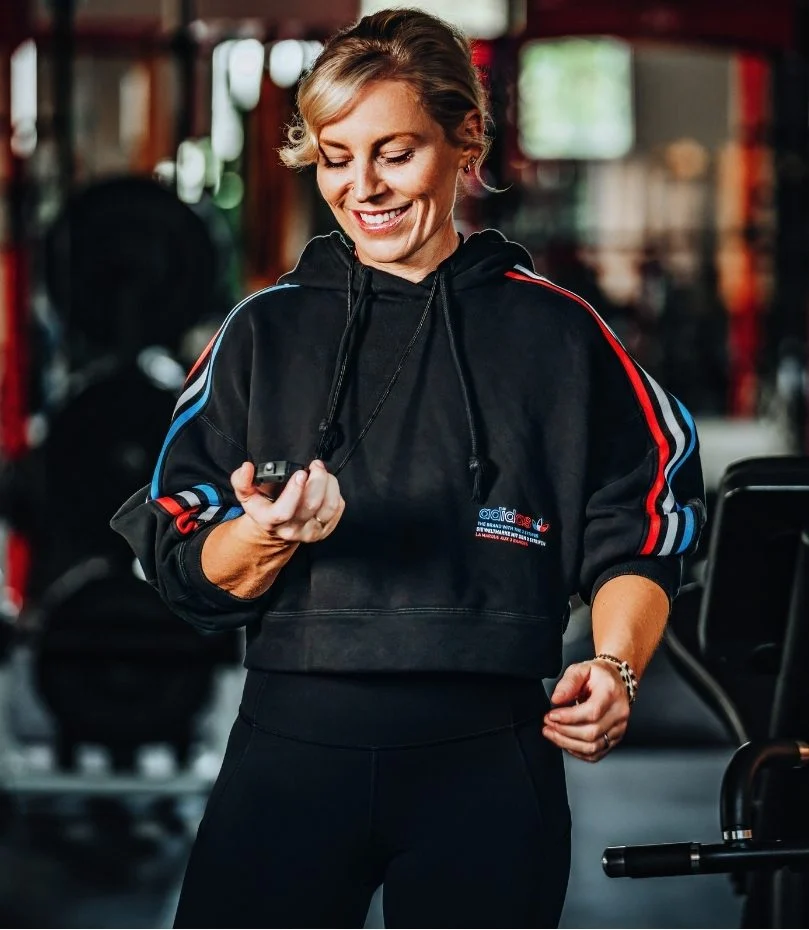 Krista looking at her stopwatch to time her client's tempo